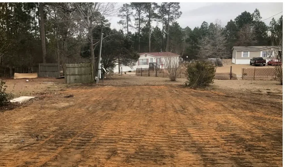 Red clay lot graded smooth after a teardown