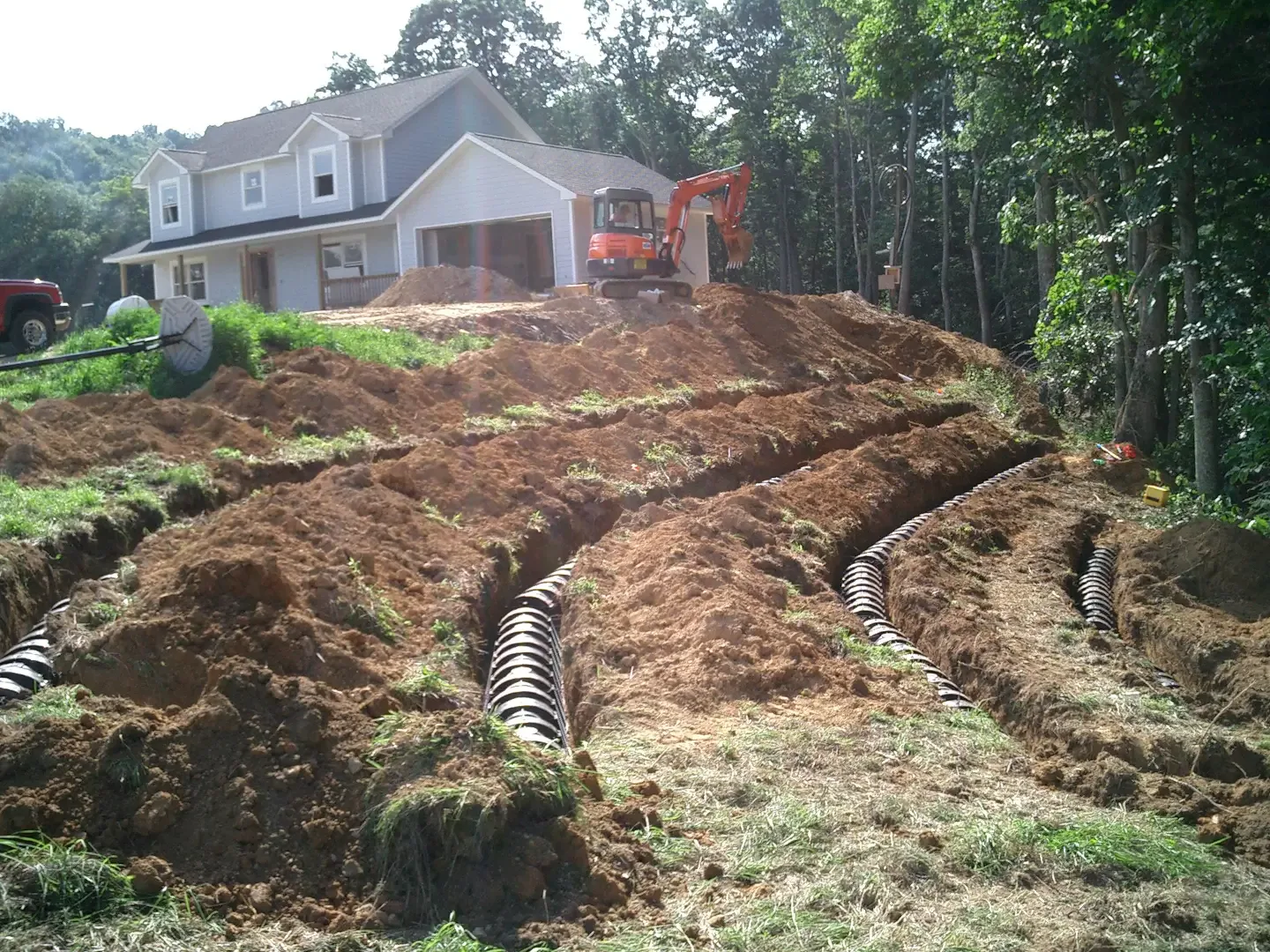 Drain field lines trenched in for a septic system install